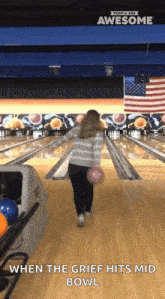 a woman throws a bowling ball in a bowling alley with the words when the grief hits mid bowl below her