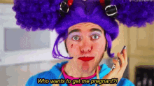 a man wearing a purple wig is talking on a cell phone and says who wants to get me pregnant ?