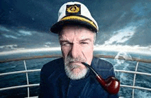 a captain is smoking a pipe on a boat .