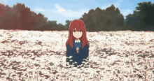 a girl in a school uniform is standing in a field of white flowers