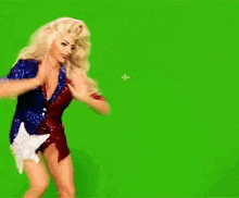 a woman in a red white and blue outfit with a star on her waist is dancing on a green screen