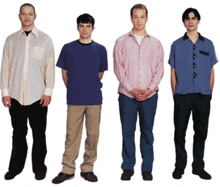 four men are standing next to each other in a row with their hands in their pockets