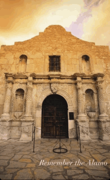 a picture of a building with the words " remember the alamo " on the bottom