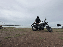 a man standing next to a motorcycle that says xd