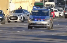 a police car is driving down a street with other cars