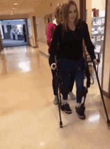 a woman with a prosthetic leg is walking down a hallway