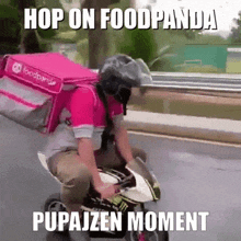 a man is riding a motorcycle with a pink bag that says foodpanda