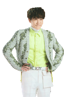 a man with his hands on his hips is wearing a green shirt and a white jacket