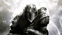 a black and white photo of a knight in armor with his arms crossed