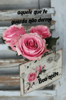 a bunch of pink roses sitting on top of a sign that says boa noite