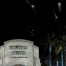 fireworks are displayed in front of the universal studios