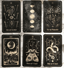 a set of tarot cards including the moon and three of wands