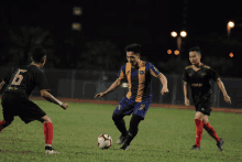 a soccer player wearing a blue and yellow jersey with the number 6 on it