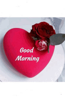 a red heart with the words `` good morning '' written on it and a rose on top of it .