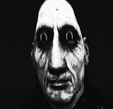 a black and white photo of a man with a scary face