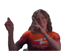 a woman wearing an orange shirt that says human powered health giving a thumbs up