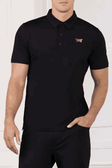 a man wearing a black polo shirt with the letters pxg embroidered on it