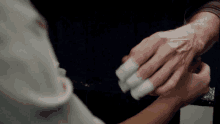 a person with bandages on their fingers is being held by another person