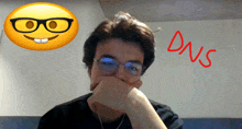 a man wearing glasses is covering his mouth in front of a smiley face and the word dns written in red