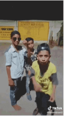 a group of young boys are posing for a picture in front of a sign that says ' lerut high school '