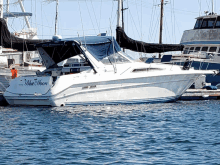 a white boat with the name blue moon on the back of it