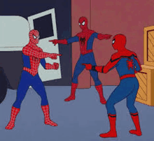 three spider men are standing next to each other in a room .