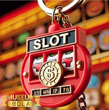 a keychain with a slot machine on it and the word slot on it