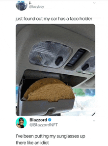 a taco holder in the rear view mirror of a car with a tweet from blazzard