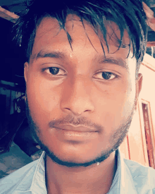 a close up of a man 's face with a beard and wet hair