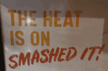 a sign that says " the heat is on smashed it " on it