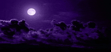 a full moon is shining through the clouds in a purple sky at night .