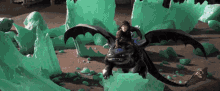 toothless and hiccup are riding a dragon in front of green crystals