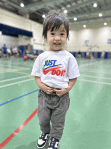 a little boy wearing a just do it t-shirt