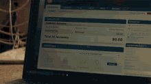 a laptop screen shows a customer accounts page with a current balance of $ 0.00