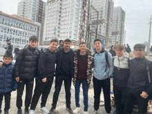 a group of young men are posing for a picture and one of them is wearing a jacket that says boss