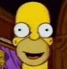 a close up of homer simpson 's face with big white eyes and a smile .