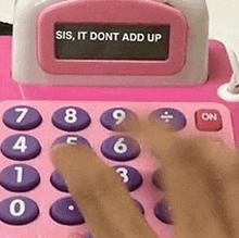 a person is using a pink calculator with the words `` sis , it dont add up '' on it .