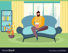 a man is sitting on a couch with a bag of popcorn