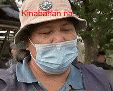 a man wearing a face mask and a hat that says kinabahan na on it