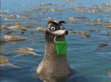 a cartoon seal holding a green bucket in its mouth