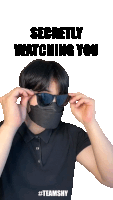 a man wearing sunglasses and a mask with the words secretly watching you below him