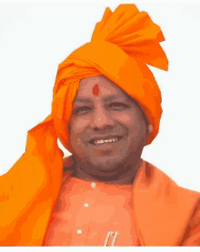 a man wearing an orange turban and an orange shirt smiles for the camera