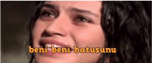 a woman is crying and the words beni beni batusunun are above her face