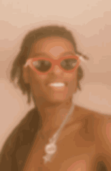 a blurry picture of a woman wearing red sunglasses