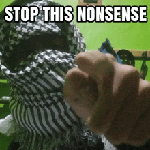 a person wearing a scarf with the words " stop this nonsense " written on it