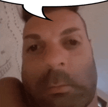 a man with a beard is looking at the camera with a speech bubble above his head