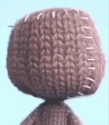 a close up of a stuffed animal 's head with stitches .