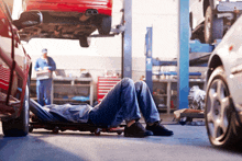 a man is laying on a workbench in a garage