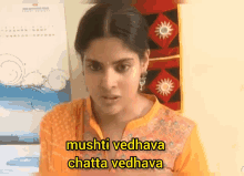 a woman in a yellow shirt says mushti vedhava