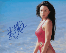 a picture of a woman in a red swimsuit is signed by a person named whistler